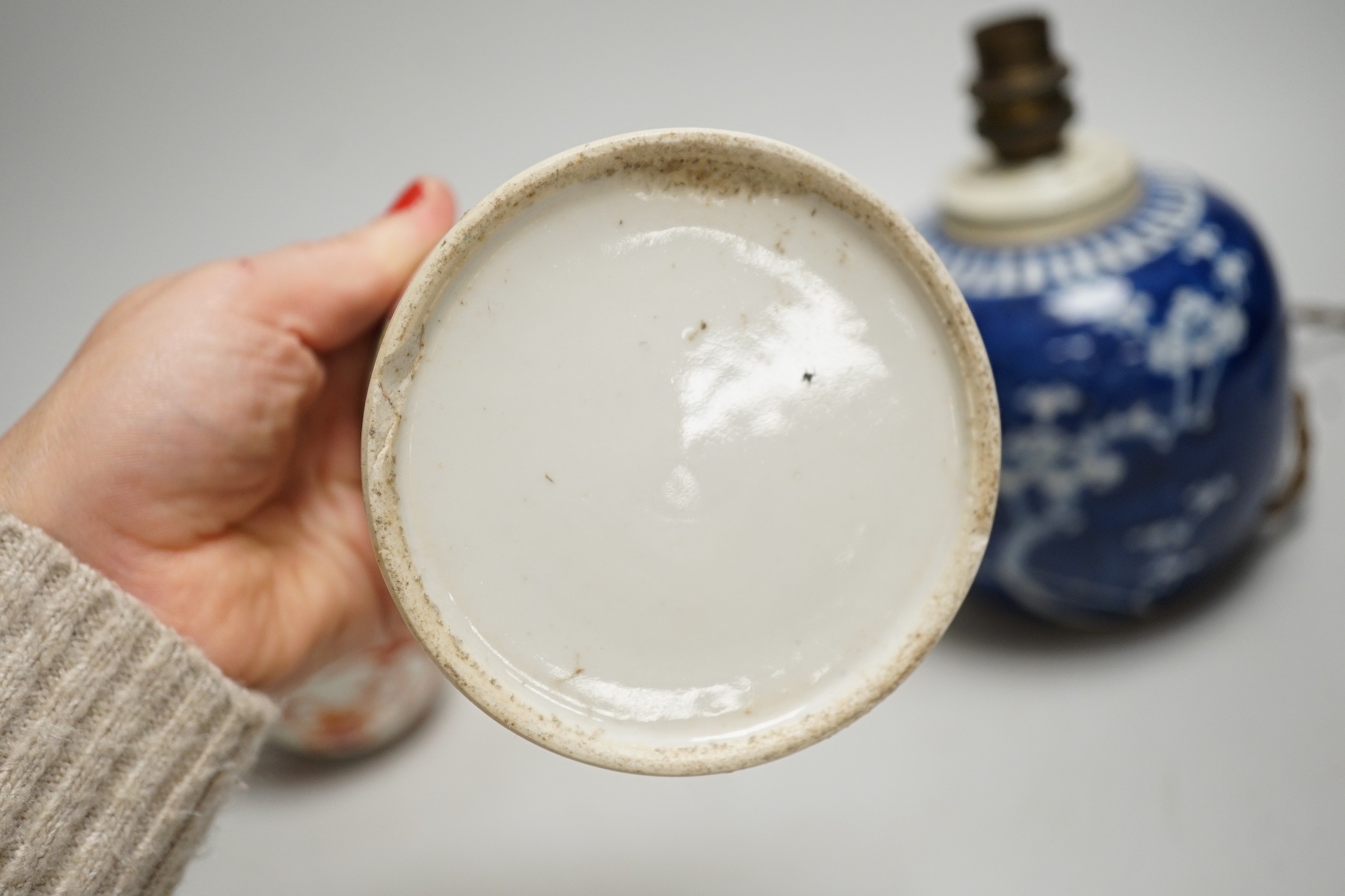 A 19th century Chinese famille rose cylindrical jar and cover, 11.5cm high, a blue and white prunus lamp and a Japanese eggshell porcelain cup